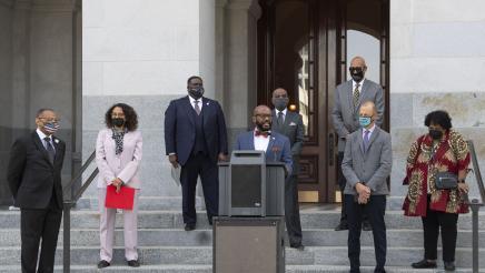 Members of the California Legislative Black Caucus watch Assemblymember Gipson speak at a press conference about the Derek Chauvin trial verdict.