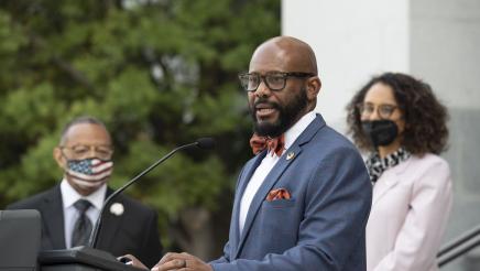 Members of the California Legislative Black Caucus watch Assemblymember Gipson speak at a press conference about the Derek Chauvin trial verdict.