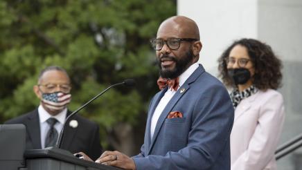 Members of the California Legislative Black Caucus watch Assemblymember Gipson speak at a press conference about the Derek Chauvin trial verdict.