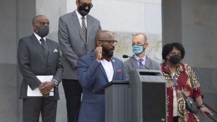 Members of the California Legislative Black Caucus watch Assemblymember Gipson speak at a press conference about the Derek Chauvin trial verdict.