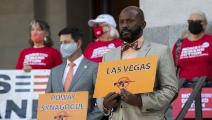 Asm. Gipson holding "Las Vegas" sign