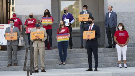 Asm. Gipson and other members holding signs