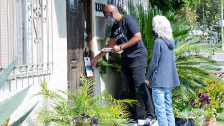 Asm. Gipson and volunteer knocking on door