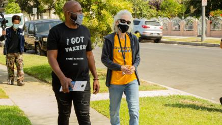 Asm. Gipson walkng through neighborhood with volunteers