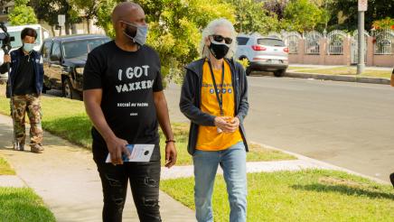 Asm. Gipson walkng through neighborhood with volunteers