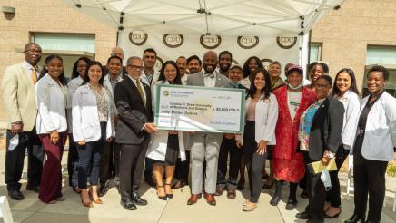 Group photo with Asm. Gipson and large check
