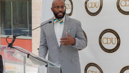 Asm. Gipson speaking at podium