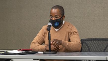 Panelist at microphone, speaking