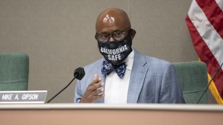 Asm. Gipson at microphone, speaking
