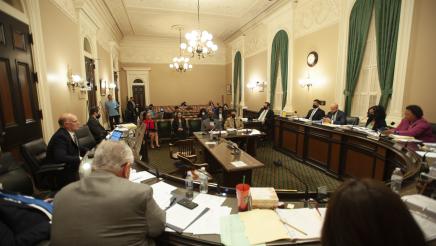 Wide view of the Assembly Public Safety Committee and hearing attendees
