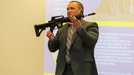 Man holding up machine gun