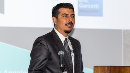 Man at podium, speaking