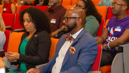 Asm. Gipson seated in audience, listening on