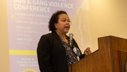 Woman at podium, speaking