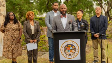 Asm. Gipson at podium, speaking to those in attendance