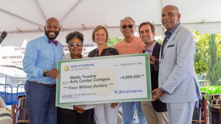 Group photo with large check being held at center