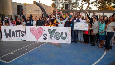 Group photo with large banner and large check held up