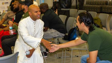 Audience members greeting each other