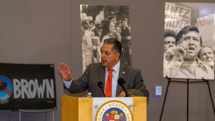 Guest speaker in suit at podium, speaking