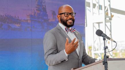 Asm. Gipson at podium, speaking
