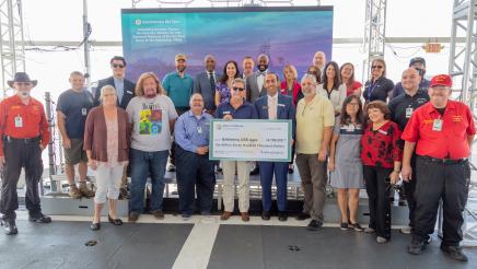 Group photo with large check held at center