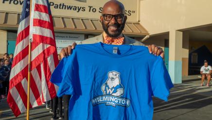 Asm. Gipson holding up a Wilmington Park logo t-shirt