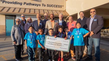 Group photo with large check held at center