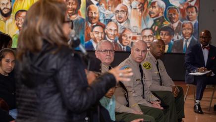 Constituent speaking while sheriffs listen on