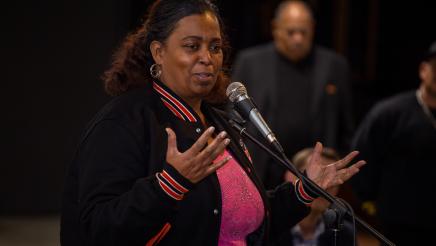 Constituent speaking while attendees listen on