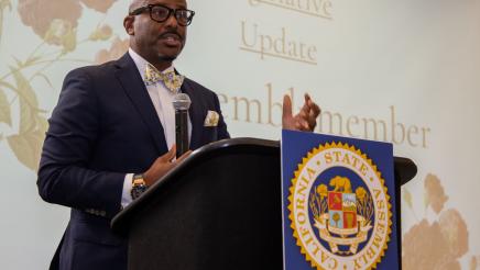 Asm. Gipson at podium, speaking