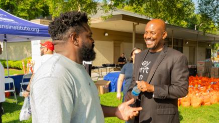 Asm. Gipson speaking with attendee