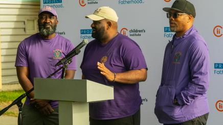Group at podium, with one member speaking
