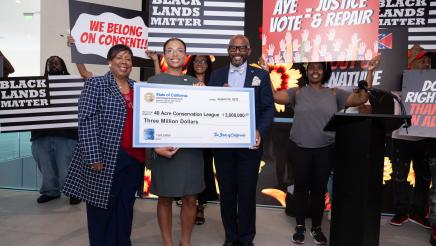 Asm. Gipson and Jade Stevens holding large check