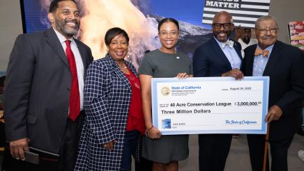 Asm. Gipson, Jade Stevens and others holding large check