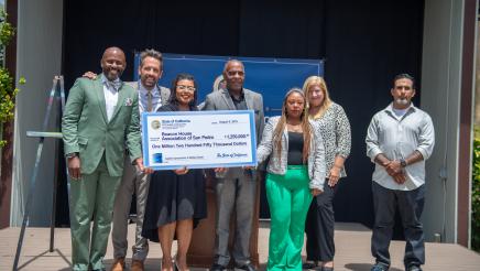 Asm. Gipson, Sen. Bradford, Exec. Dir. Hoggan and others holding large ceremonial check