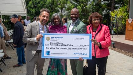 Asm. Gipson, Sen. Bradford and others holding large ceremonial check