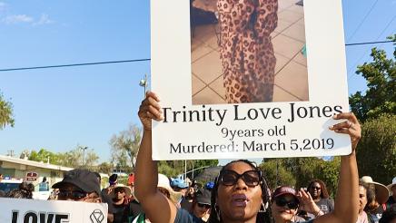 March participants holding signs with photos and slogans