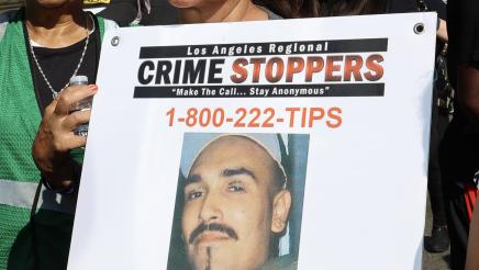 March participant holding sign with photo and text