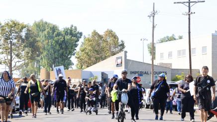 Many marchings walking down street
