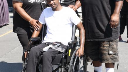 Asm. Gipson and two other participants, gathered around participant in wheelchair