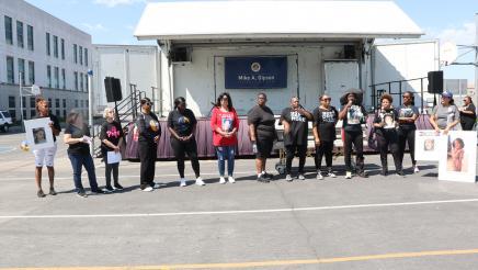 Participants standing in line in front of coffin
