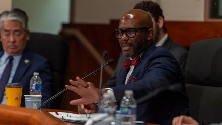 Asm. Gipson holds out hand while addressing witnesses