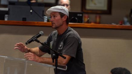 Audience member speaking at podium
