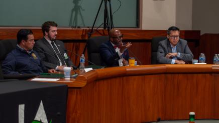 Asm. Gipson holds up hand while addressing audience member