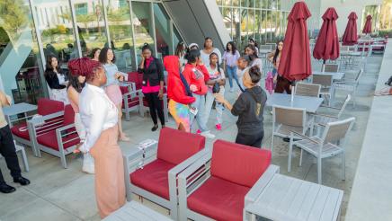 Attendees gathered on outdoor patio conversing
