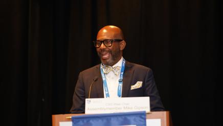 Asm. Gipson presenting at a podium 