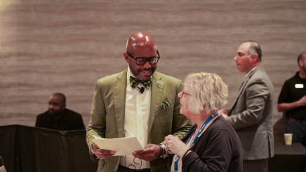 Asm. Gipson talking with conference participant