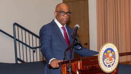 Hospital administrator at podium, speaking