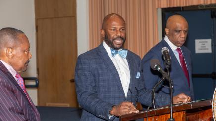 Asm. Gipson at podium, speaking
