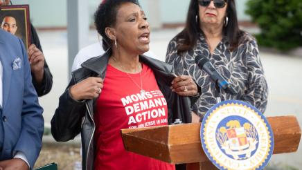 Guest speaker at podium, displaying printed shirt
